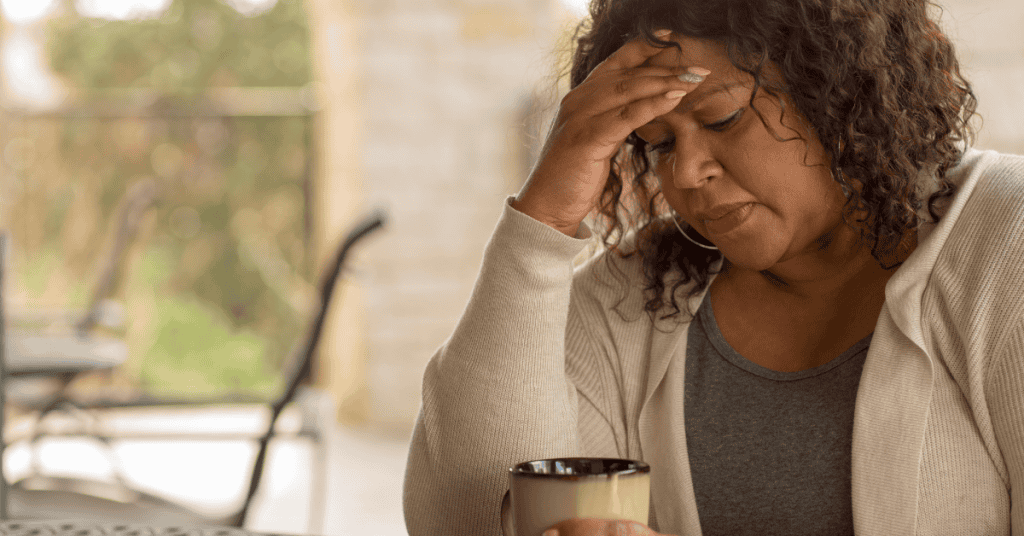 Frustrated woman sits with head in hands. Coaching can leave us feeling frustrated if we are not ready or are looking for information rather than action