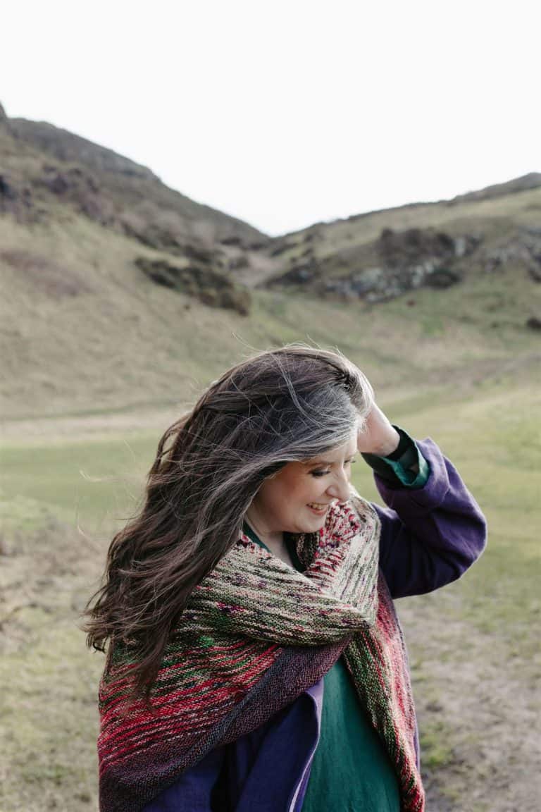 ADHD awareness woman outdoors with wind-blown hair and colourful scarf.